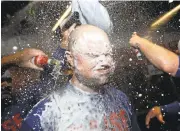  ?? DAVID J. PHILLIP/ASSOCIATED PRESS ?? Pitcher Jon Lester is doused with champagne as the Cubs celebrate the franchise’s first pennant in 71 years.