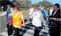  ??  ?? Leanne Larmer, NZNO union organiser, leading the Horowhenua Community Practice nurses out to Liverpool St to start their strike action.