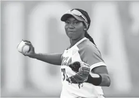  ?? VERA NIEUWENHUI­S/AP ?? Defending NCAA champion UCLA and player Kinsley Washington saw the softball season canceled after it started because of the pandemic.