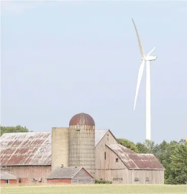  ?? LARS HAGBERG / THE CANADIAN PRESS ?? Wind turbines at the White Pines project near a farm in Milford, Ont. Doug Ford’s government in Ontario aims to cancel the contract for the project, which could drive away future investment in the province, John Ivison writes.