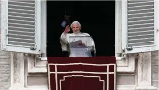  ?? (Alessandro Bianchi/Reuters) ?? POPE BENEDICT XVI waves in St. Peter’s Square at the Vatican yesterday as he leads the Sunday Angelus prayer.