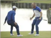  ?? MATT DURHAM - THE ASSOCIATED PRESS ?? Europe’s Alex Noren, right, celebrates with Thorbjorn Olesen, second left, after winning his a singles match on the final day of the 42nd Ryder Cup at Le Golf National in Saint-Quentin-en-Yvelines, outside Paris, France, Sunday, Sept. 30, 2018.