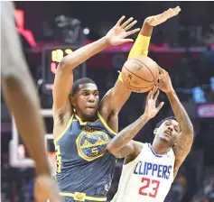  ?? — TODAY Sports photo ?? Golden State Warriors forward Kevon Looney fouls Los Angeles Clippers guard Lou Williams (right) in the closing seconds of the Clippers 121-116 overtime win at Staples Centre.