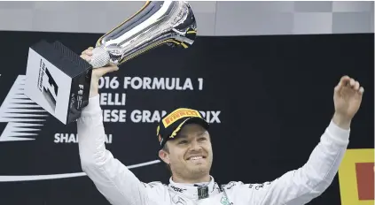 ?? Picture: AFP ?? HAT-TRICK. Mercedes driver Nico Rosberg celebrates with his trophy after winning the Formula One Chinese Grand Prix in Shanghai yesterday.