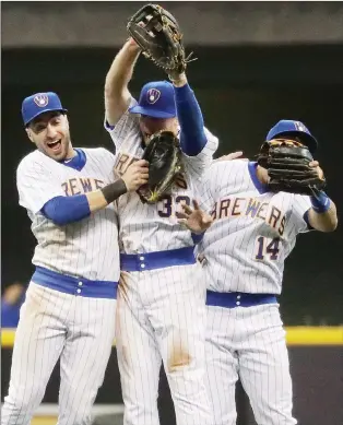  ?? AP PHOTO ?? Milwaukee Brewers’ Ryan Braun, Brett Phillips and Hernan Perez celebrate after the ninth inning of a game against the Philadelph­ia Phillies on July 15 in Milwaukee.