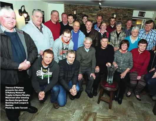  ??  ?? Theresa O’Mahony presents the John O’Mahony Memorial Trophy to Danny Murphy, Millstreet after winning the Denis Horgan Road Bowling Club League in Banteer Photo by John Tarrant