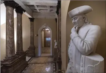  ?? J. SCOTT APPLEWHITE — THE ASSOCIATED PRESS ?? A statue of Benjamin Franklin stands in an empty corridor outside the Senate at the Capitol in Washington on Thursday.