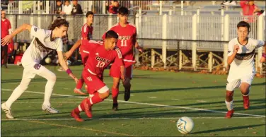  ?? MIKE BUSH/NEWS-SENTINEL ?? Galt soccer players Davian Marquez (10) and Alexis Gonzalez (11) race toward the ball with Franklin's Griffin Schanning (2) and Raul Campus (22) during a non-league game at Walker Park on Friday.