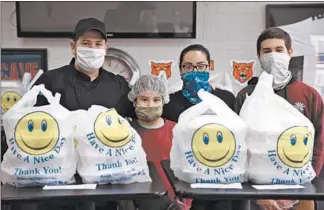  ?? STACEY WESCOTT/CHICAGO TRIBUNE ?? Pablo Sanchez, from left, Erika Sanchez, 10, Erika Castro and Pablo Sanchez, 15, at the family’s restaurant, Gyros Planet in Evanston on April 23, 2020.