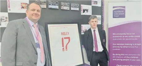  ??  ?? Rob Tarn, left, presents Joe Ridley with a framed England team shirt.