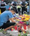  ?? Picture: REUTERS ?? SAD MOMENT: A man lights a candle at an impromptu memorial where a van crashed into pedestrian­s at Las Ramblas in Barcelona, Spain yesterday