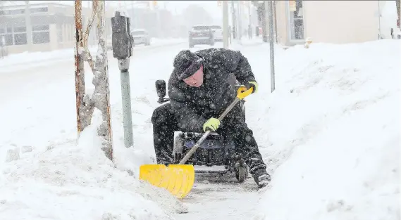  ?? NICK BRANCACCIO ?? From the seat of his mobility scooter, Don Hamel clears snow from the Erie Street East sidewalk on Friday.
