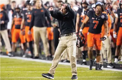  ?? AP Photo/Sue Ogrocki ?? ■ Oklahoma State coach Mike Gundy gestures Saturday during the second half of the team's NCAA college football game against Oklahoma in Stillwater, Okla.