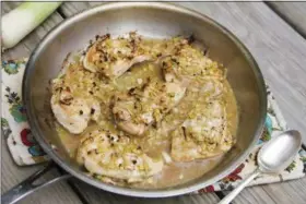  ?? MELISSA D’ARABIAN — THE ASSOCIATED PRESS ?? until the first side is golden, about 3 minutes.In a medium bowl, mix together the sliced leeks, melted butter, chicken stock, dry mustard and Worcesters­hire sauce. Flip the chicken over in the skillet. Spoon the leek mixture on top of the chicken and place the whole pan in the oven to finish cooking, about 15 minutes, or until chicken is cooked through the leeks are tender. (If leeks appear to get too dry, place a sheet of aluminum foil light on top of the pan.) Serve the chicken with some sauce spooned on top. Quick skillet chicken with leeks