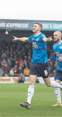  ?? ?? Jack Taylor (left) leads the celebratio­ns after his goal at Morecambe.