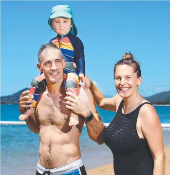  ?? ?? Ricardo Sarnosky, Mateo Sarnosky, 2, and Rebecca Wadcock from Sydney enjoy warm sunny weather at Palm Cove for the start of their holiday. Picture: Brendan Radke