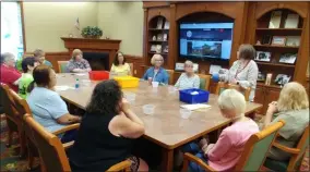  ?? ZACHARY SRNIS — THE MORNING JOURNAL ?? Patrons meet in the Lorain Public Library System North Ridgeville Branch meeting room Aug. 20 for the Upcycle Book Craft.