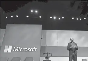  ?? TED S. WARREN/AP ?? Microsoft CEO Satya Nadella speaks during the annual Microsoft Corp. shareholde­rs meeting in Bellevue, Wash. Microsoft on Friday surpassed Apple as the world’s most valuable publicly traded company. Under Nadella, Microsoft has found stability by moving away from its flagship Windows operating system and focusing on cloud-computing services with long-term business contracts.