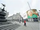 ?? /AFP ?? Head of
state: The giant billboard in Piccadilly Square, London, displays a still image from Queen Elizabeth II’s address to the nation on April 18.