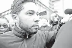  ??  ?? Smollett leaves Cook County jail after posting bond on Thursday. (Below left) People believed to be family members of Smollett leave the Cook County courthouse following the actor’s bond hearing, and (right) Smollett (partially obscured) leaves Cook County jail. — AFP photos