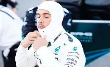  ??  ?? Mercedes driver Lewis Hamilton waits in the pits during a temporary halt in the Azerbaijan Grand Prix at the Baku city circuit on June 25.