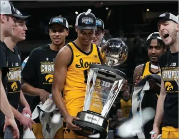  ?? The Associated Press ?? Iowa forward Keegan Murray, center, holds the trophy as he celebrates with teammates after an NCAA college basketball game against Purdue at the Big Ten Conference tournament in this file photo.