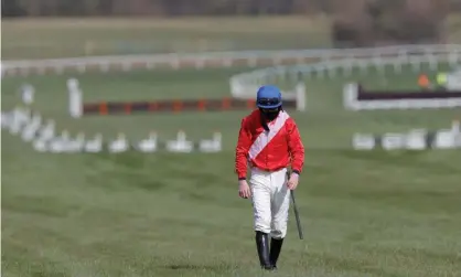  ??  ?? A distraught Jack Kennedy walks back along the course after falling from Envoi Allen, but his mishap was good news for one punter at least. Photograph: Tom Jenkins/The Guardian