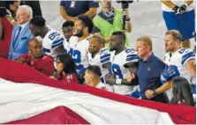  ?? ASSOCIATED PRESS FILE PHOTO ?? Dallas Cowboys owner Jerry Jones, left, and head coach Jason Garrett, second from right, stand with their players for the national anthem prior to their game against Arizona in September.