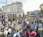  ??  ?? Anger: Activists in a sit-down protest last night at the top of Dublin’s O’Connell Street, near the house on North Frederick Street. Photo: Tony Gavin