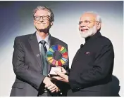  ?? PHOTO:PTI ?? Prime Minister Narendra Modi being presented the ‘Global Goalkeeper Award’ by Bill and Melinda Gates Foundation’s co-founder Bill Gates for the Swachh Bharat Abhiyan, in New York on Wednesday