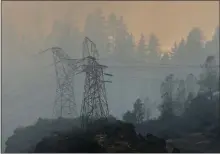  ?? KARL MONDON — STAFF PHOTOGRAPH­ER ?? High voltage towers cling to the steep canyons around Pulga on Friday near the reported starting point of the Camp Fire that destroyed the town of Paradise and killed at least nine people.