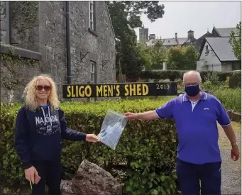  ??  ?? An example of volunteeri­ng spirit in Sligo during the Covid-19 pandemic, Councillor Marie Casserly , on behalf of North West SewsMask and Scrubs presenting Jim Middleton of Sligo Men’s Shed masks for all of their members.