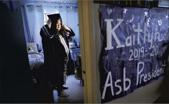  ?? Christina House Los Angeles Times ?? AT HOME in Montclair, Kaitlyn Nguyen tries on her graduation cap and gown. Nguyen is grateful to have had a college coach to help her with the applicatio­n process.