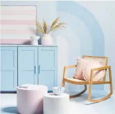  ??  ?? Sugary pastels make a sweet statement in on solid surfaces, horizontal stripes and an eye-catching curved mural, pairing perfectly with the natural tones of the chair and grasses.