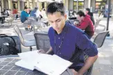  ?? Paul Chinn / The Chronicle ?? Neeraj Dharmadhik­ari, who has an H-4 visa, studies for a physics class at De Anza College.