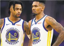  ?? D. Ross Cameron / Special to The Chronicle ?? Warriors guards D’Angelo Russell (0) and Jacob Evans talk during a timeout late in the Warriors’ opening loss Thursday.