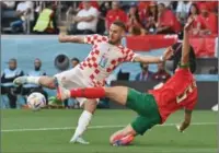  ?? (AFP) ?? Croatia’s midfielder Nikola Vlasic (left) shoots but fails to score as Morocco’s defender Nayef Aguerd defends during the FIFA World Cup Qatar 2022 Group F match at the Al-Bayt Stadium in Al Khor recently.