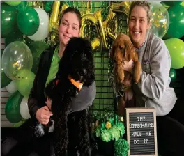  ?? Staff Photo/Brent Melton ?? Mackenzie Vorhees (L) holds Rusty, Coldwater School’s therapy dog, while Jessica Skaggs (R) hold Ripsey, a puppy in training on Thursday afternoon at K9to5 Doggy Daycare.