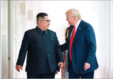  ?? KCNA VIA KNS/AFP ?? US President Donald Trump (right) and North Korea’s leader Kim Jong-un walk to attend their historic summit, at the Capella Hotel on Sentosa island in Singapore, on Tuesday.