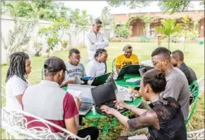  ?? AFP ?? Christophe Guignement (left), scriptwrit­er and author of cartoons and co-founder of the Maison Junior associatio­n, teaches participan­ts of the residency in Alogavi, Togo.