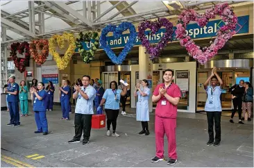  ??  ?? CLAPPING FOR CARERS: Heroism of NHS staff is paying off with fewer deaths and patients