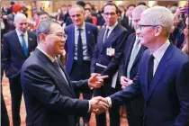  ?? FENG YONGBIN / CHINA DAILY ?? Premier Li Qiang shakes hands on Sunday with Apple CEO Tim Cook after the opening ceremony of the China Developmen­t Forum 2024 in Beijing.
