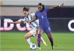  ?? RYAN SUN/AP ?? United States forward Jaedyn Shaw, front, and Argentina defender Eliana Stábile vie for the ball Friday in Carson, Calif.