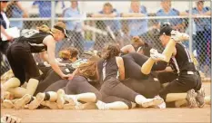  ?? Christian Abraham / Hearst Connecticu­t Media ?? Woodland teammates pile onto each other after their win over Oxford in the Class M state championsh­ip game on Saturday.