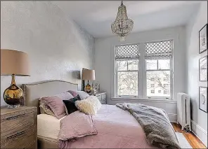  ??  ?? Continuing with the girly-glam theme, the designers added a sparkly chandelier, faux fur throw and pale lavender bedding in Louisa Bargeron’s bedroom.