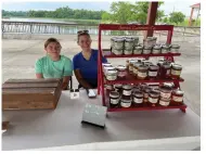  ?? (Special to The Commercial/Deborah Horn) ?? Amanda Jones (right), proprietor of Jones Canning Co. in White Hall, and her daughter, Ella, sell homemade jellies at the Pine Bluff Farmers Market at Saracen Landing. The products are also available online.