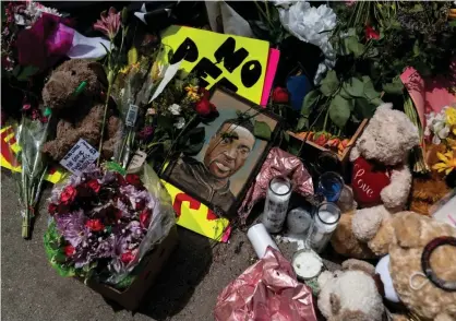  ??  ?? A memorial lies outside the Cup Foods, where George Floyd was killed in police custody, on 28 May 2020 in Minneapoli­s, Minnesota. Photograph: Stephen Maturen/Getty Images