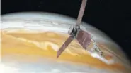  ?? NASA VIA AP ?? This image shows san artist’s rendering of NASA’s Juno spacecraft making a close pass over Jupiter.