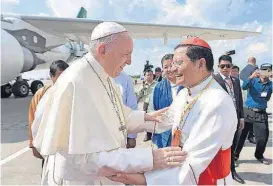  ?? [L’OSSERVATOR­E ROMANO/POOL PHOTO VIA THE ASSOCIATED PRESS] ?? Pope Francis is welcomed by Cardinal Charles Maung Bo on Monday upon his arrival at the airport in Yangon, Myanmar.