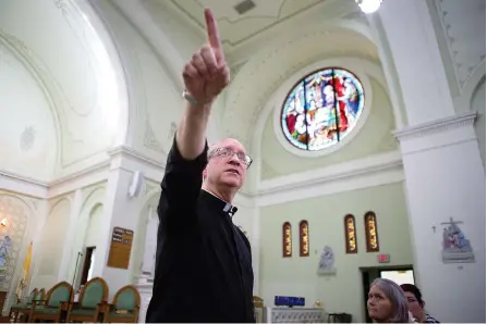  ?? Staff photo by Evan Lewis ?? The Rev. James West talks about the different images portrayed in the stained glass windows at St Edwards Catholic Church in downtown Texarkana, Ark., during the first of a series of weekly two-hour classes that will run through the end of March....